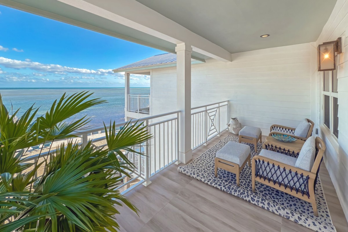 Primary Suite Private Balcony | Located off the primary suite, offers seating for two, and ocean view.