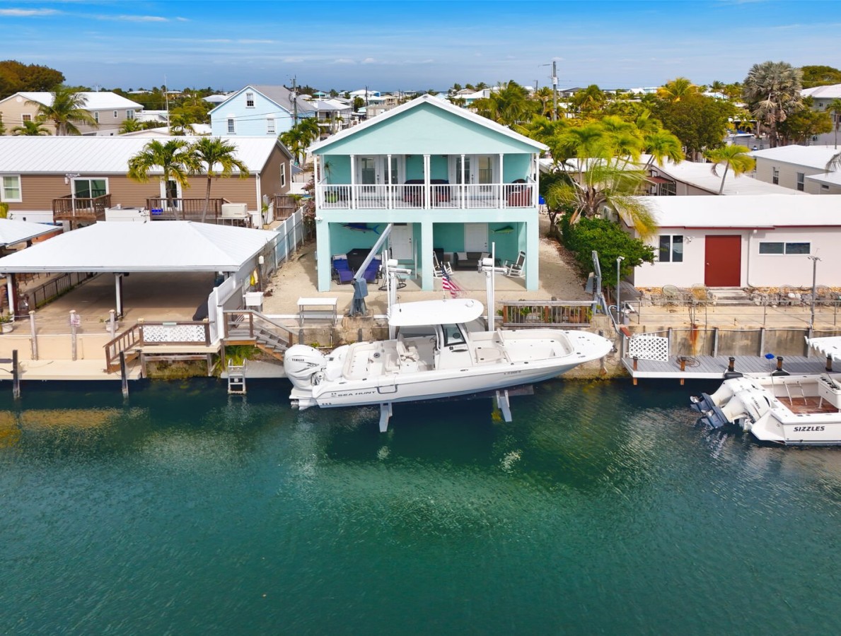 Backyard | Private boat dock offers 40 feet of waterfront + easy access to Blackwater Sound and ocean side via Adams Cut.