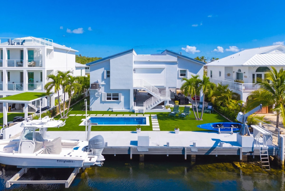 Backyard | Private boat dock offers direct ocean access, with lounge chairs positioned for soaking up the breeze or enjoying the waterfront view.